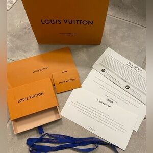 Louis Vuitton box and papers and Chanel